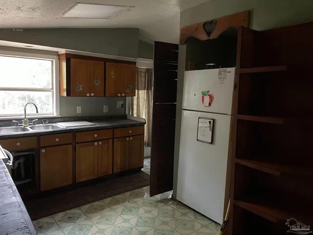a kitchen with a sink and refrigerator
