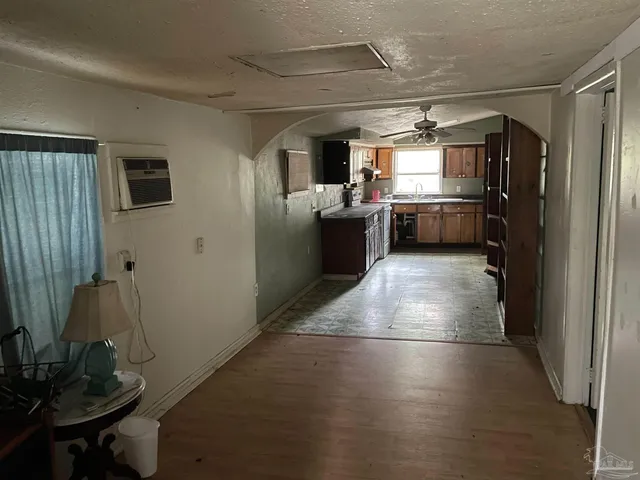 a kitchen with refrigerator and window