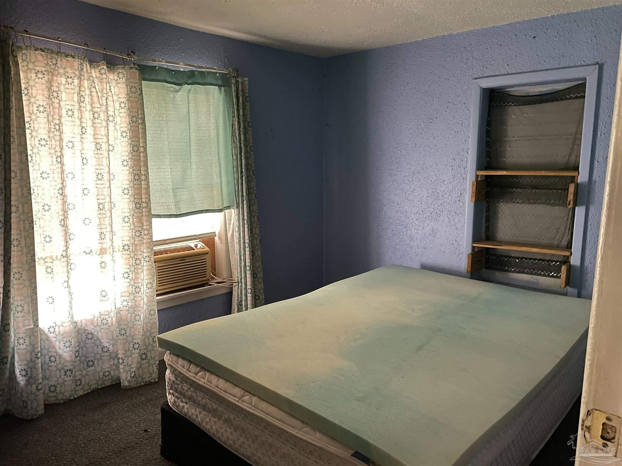 451 East Cane Avenue Crestview, FL 32539 - Photo 9 of 22 a room with a bed and a window