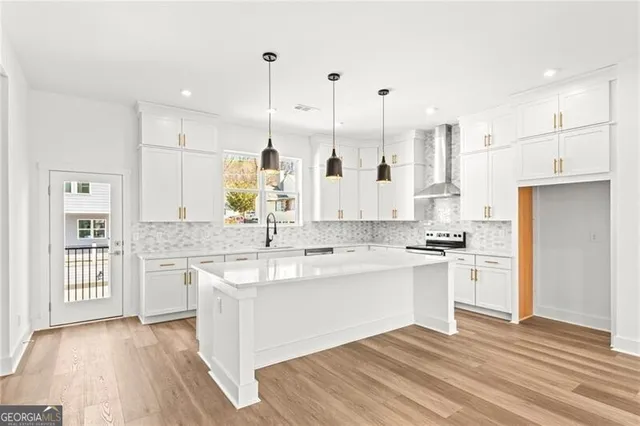 a kitchen with stainless steel appliances granite countertop a sink stove and refrigerator