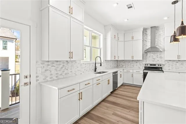 a kitchen with granite countertop white cabinets and white appliances