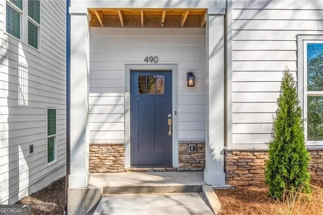 a front view of a house with a garden