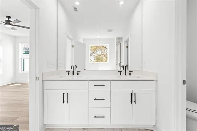 a bathroom with double vanity sink a mirror and vanity