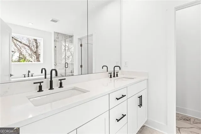 a white bath tub sitting next to a white sink