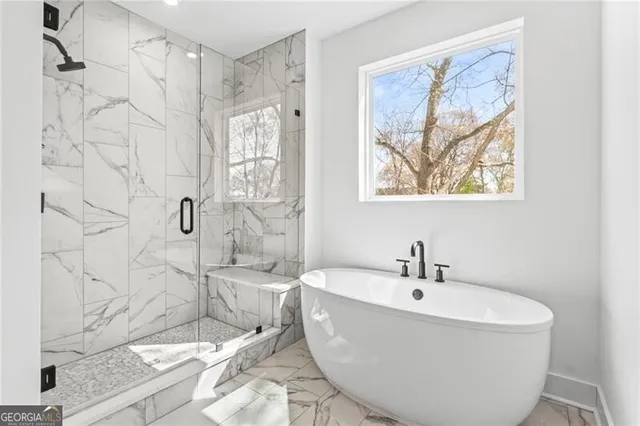 a white bath tub sitting next to a white sink