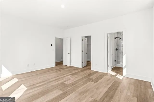 a view of an empty room with wooden floor