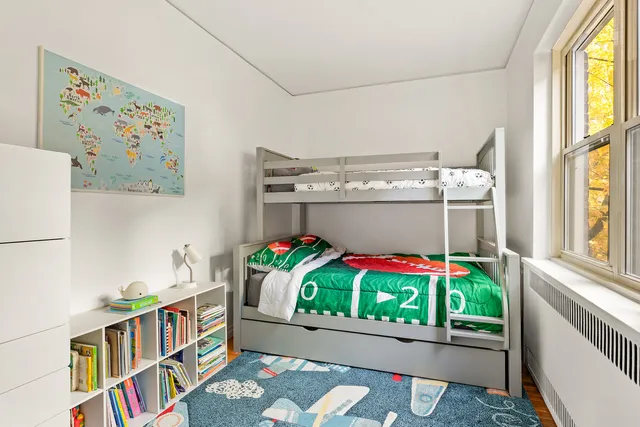 a bedroom with a bed and painting on the wall