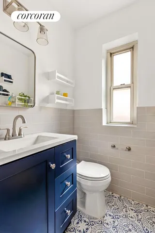 a living room with furniture fireplace and a large window