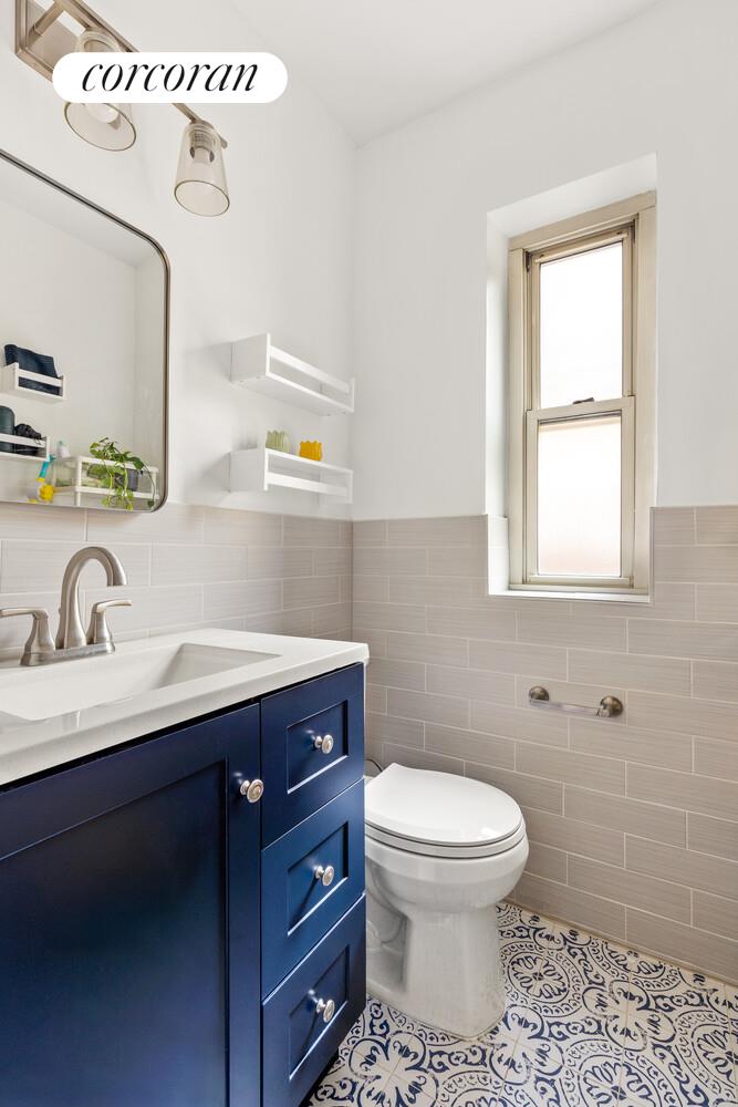 530 East 90th Street, Unit 5H Manhattan, NY 10128 - Photo 8 of 15 a bathroom with a toilet sink and mirror