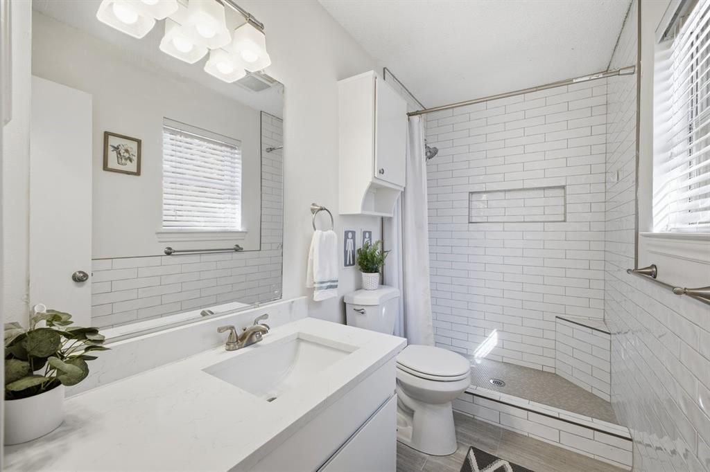 907 Roaring Springs Road Fort Worth, TX 76114 - Photo 18 of 27 a bathroom with a sink a toilet and shower