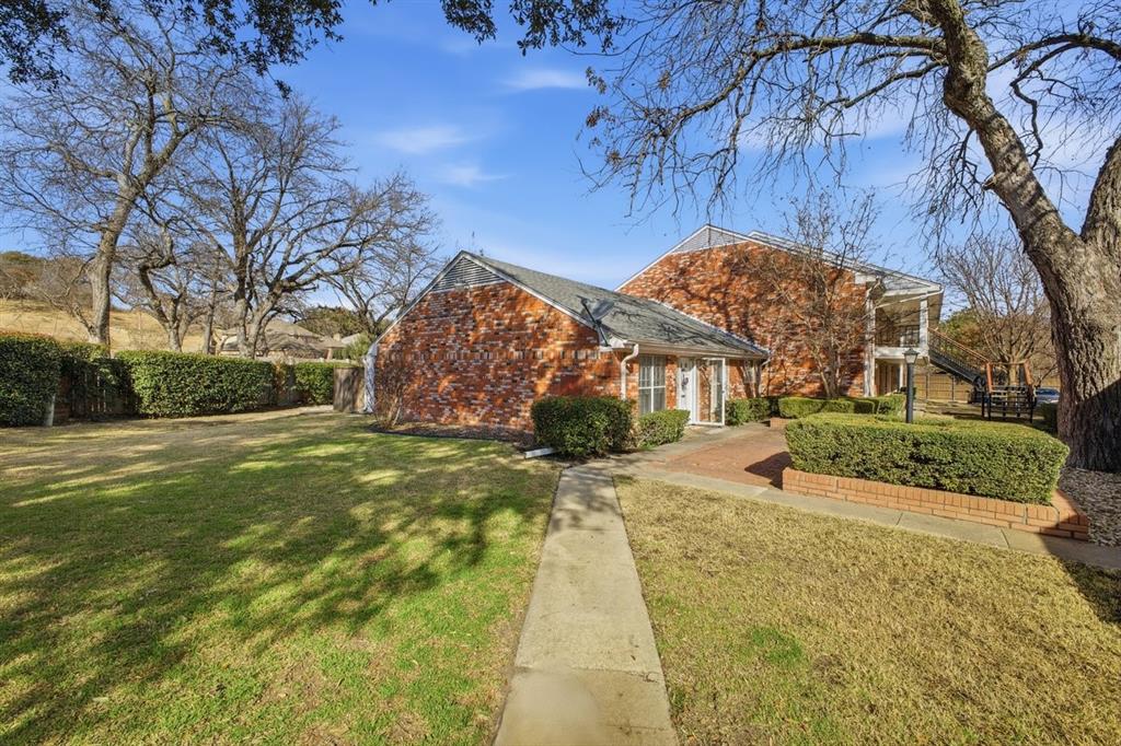 907 Roaring Springs Road Fort Worth, TX 76114 - Photo 4 of 27 a view of a yard with plants and a large tree