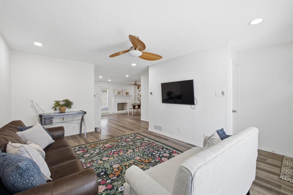 907 Roaring Springs Road Fort Worth, TX 76114 - Photo 6 of 27 a living room with furniture and a flat screen tv