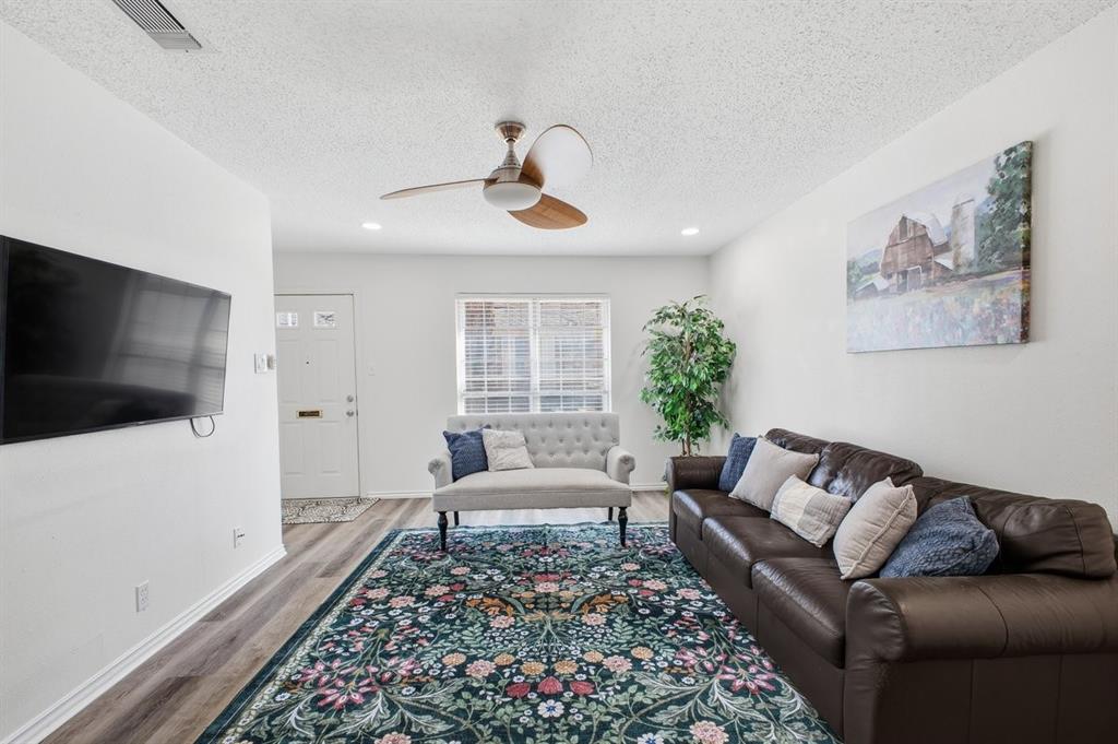 907 Roaring Springs Road Fort Worth, TX 76114 - Photo 8 of 27 a living room with furniture and a flat screen tv