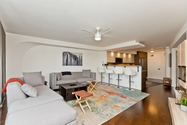 a living room with furniture and wooden floor