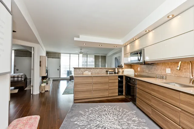 a kitchen with a stove and white cabinets