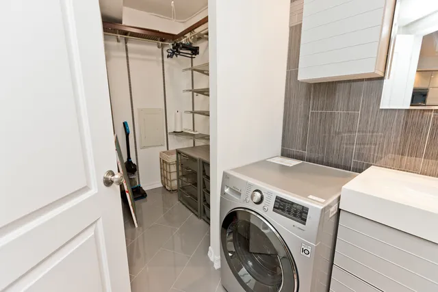 a view of storage and utility room with washer and dryer