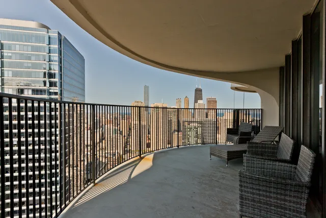 a view of a balcony with seating space