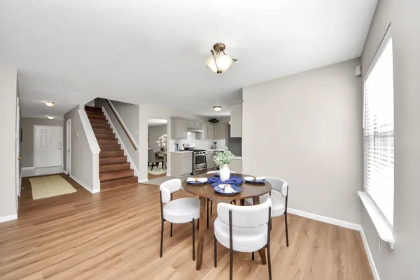 a view of a dining room with furniture wooden floor and chandelier
