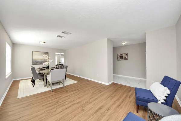 a view of a dining room with furniture and wooden floor