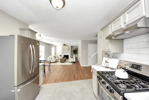 a kitchen with stainless steel appliances granite countertop a stove a refrigerator and a stove