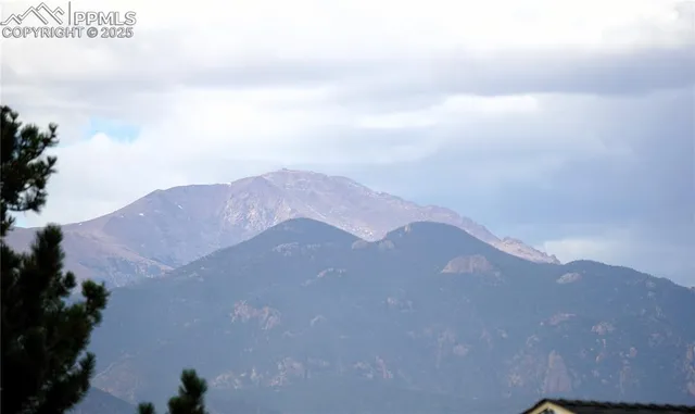 a view of a house with a mountain in the background