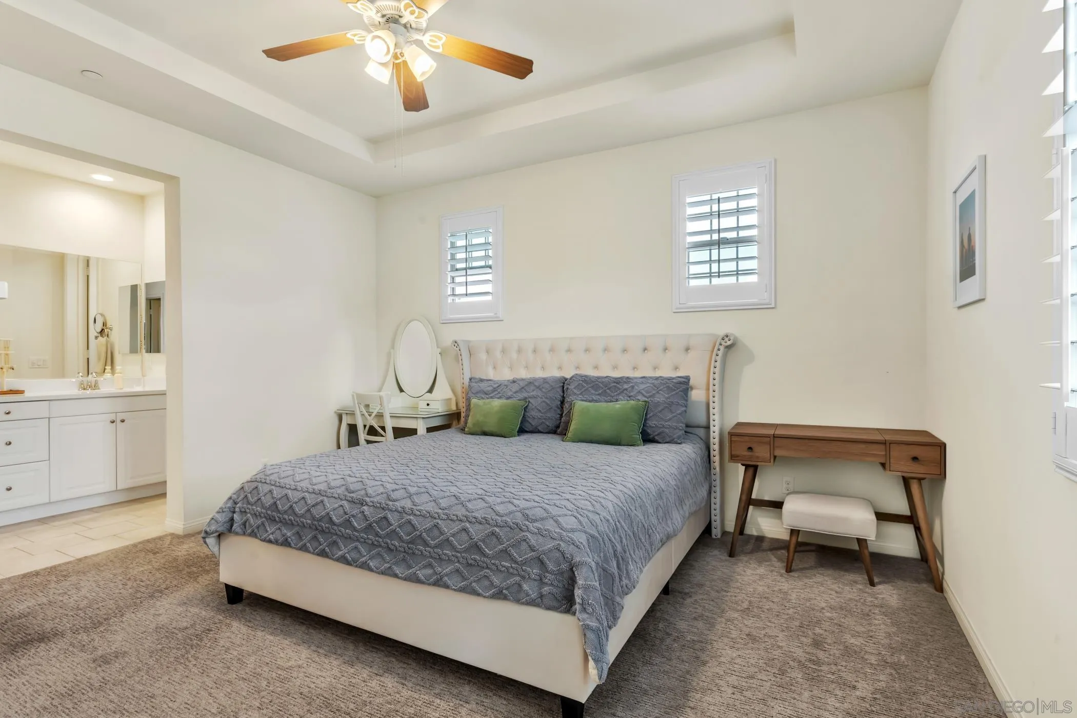 4307 Star Path Way, Unit 1 Oceanside, CA 92056 - Photo 13 of 34 a bedroom with a bed and a chandelier