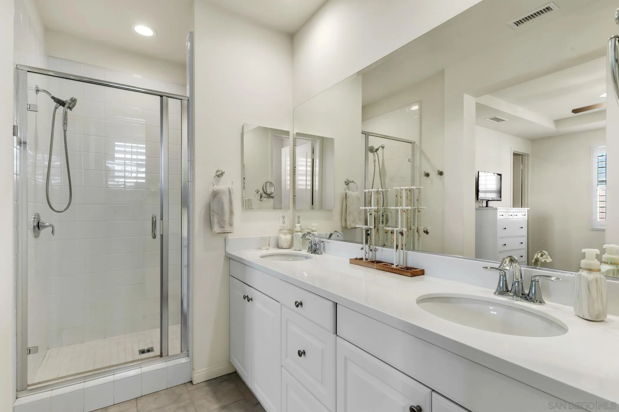 4307 Star Path Way, Unit 1 Oceanside, CA 92056 - Photo 14 of 34 a bathroom with double vanity sinks and a mirror