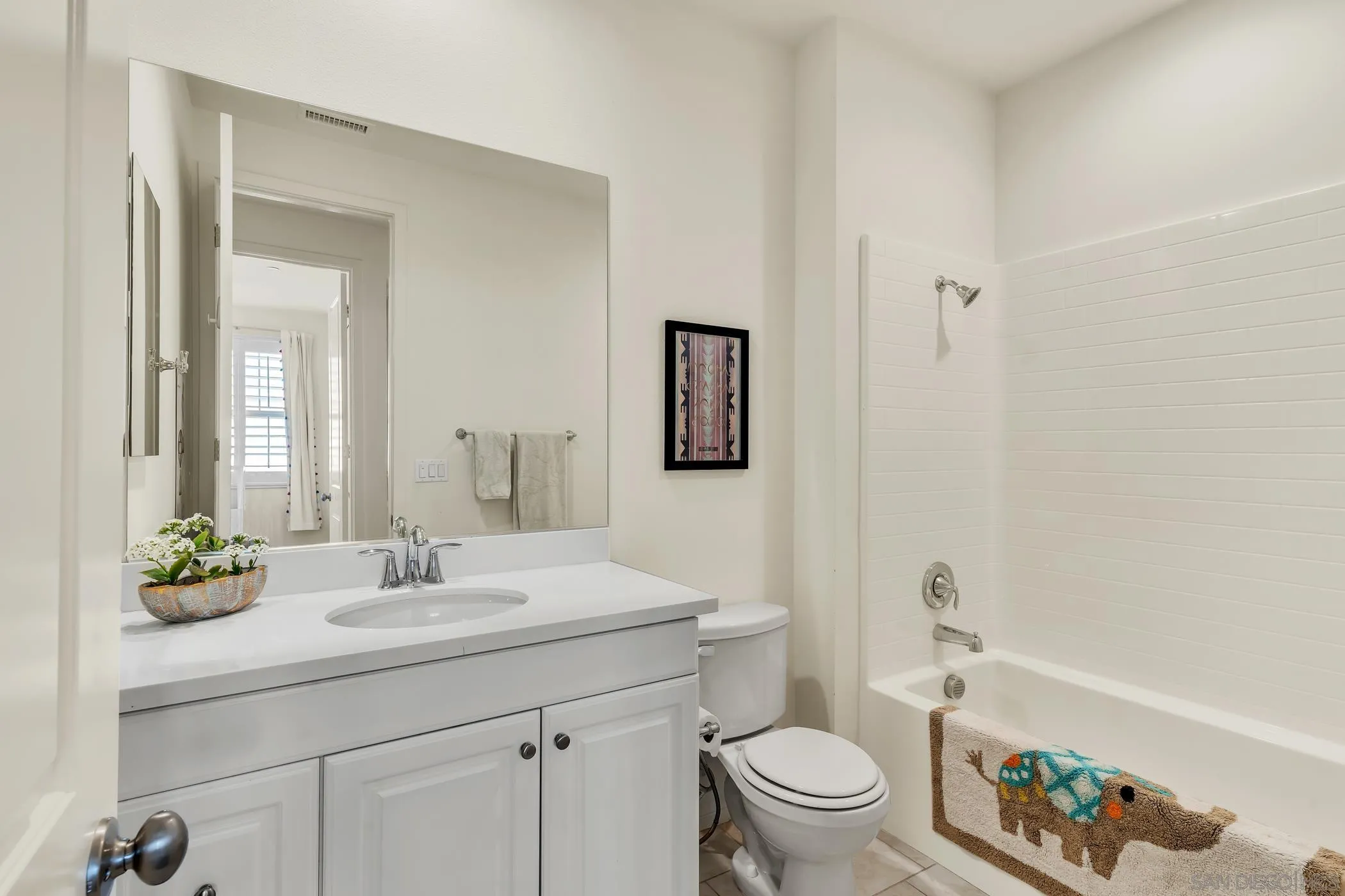 4307 Star Path Way, Unit 1 Oceanside, CA 92056 - Photo 17 of 34 a bathroom with a sink a toilet and a large mirror