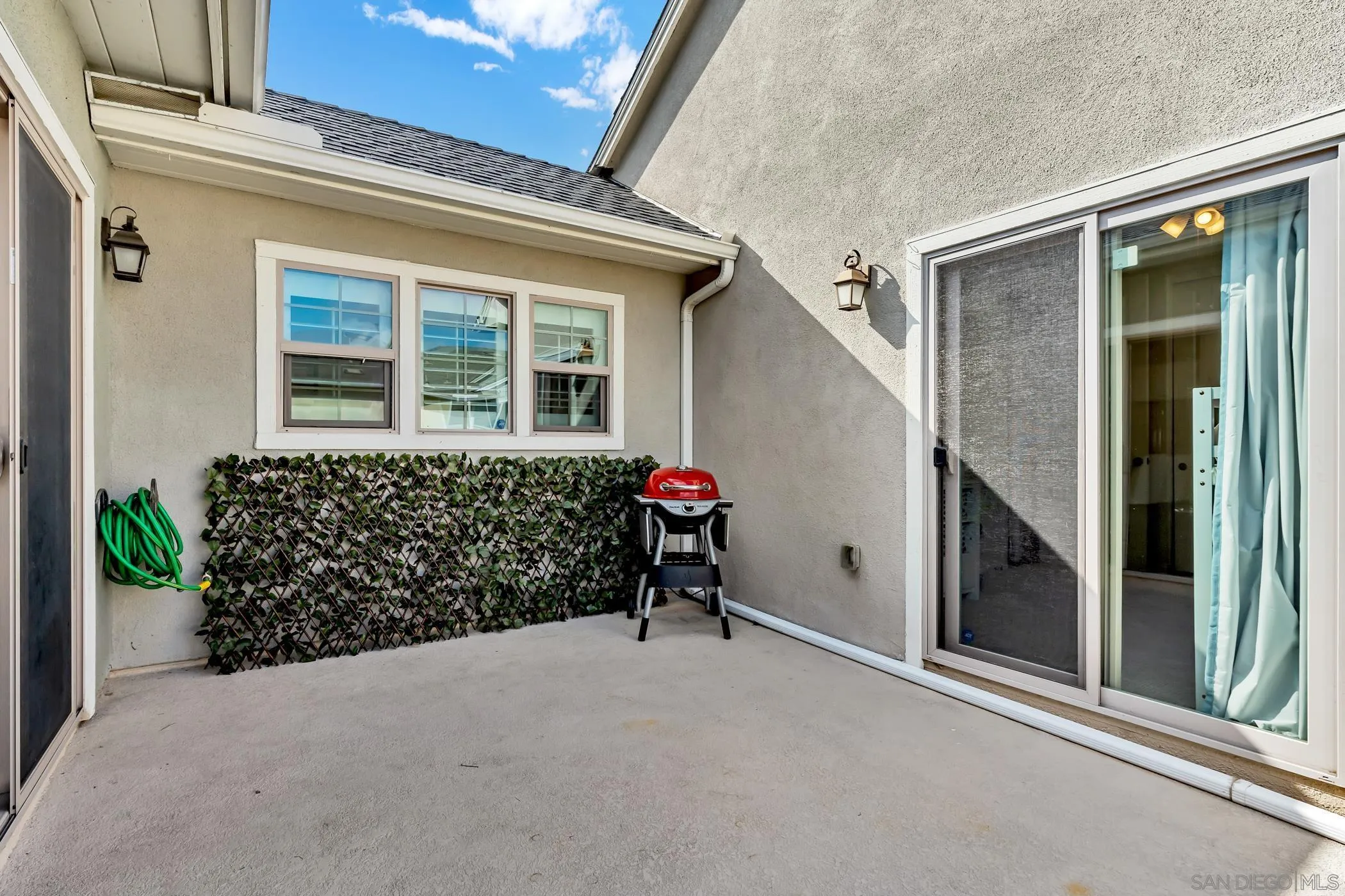 4307 Star Path Way, Unit 1 Oceanside, CA 92056 - Photo 18 of 34 front view of a house with a large window and potted plants