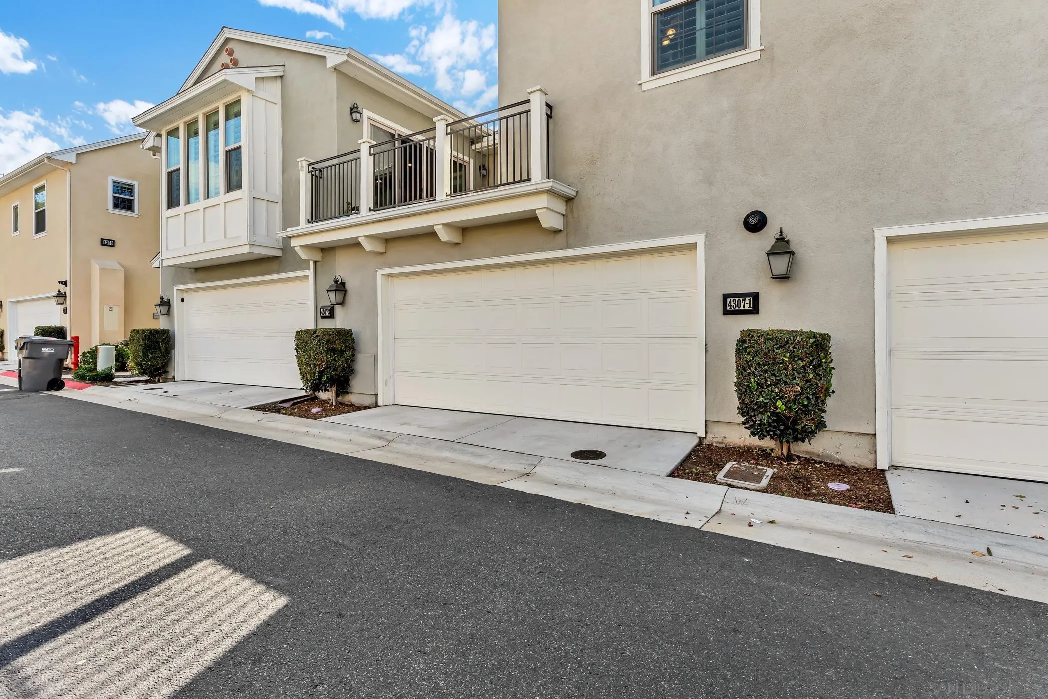 4307 Star Path Way, Unit 1 Oceanside, CA 92056 - Photo 20 of 34 a view of a white house with a street