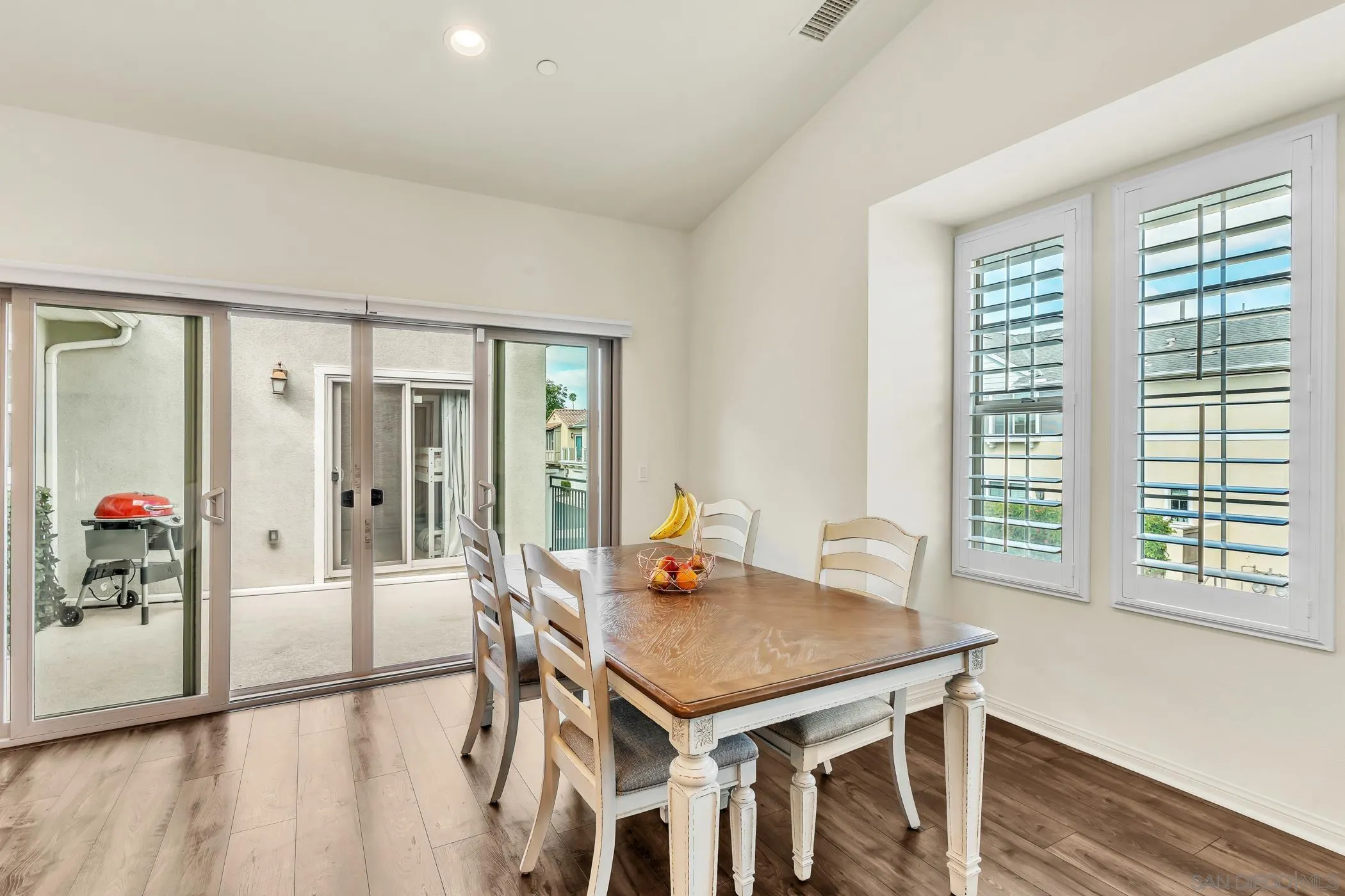 4307 Star Path Way, Unit 1 Oceanside, CA 92056 - Photo 8 of 34 a view of a dining room with furniture and wooden floor