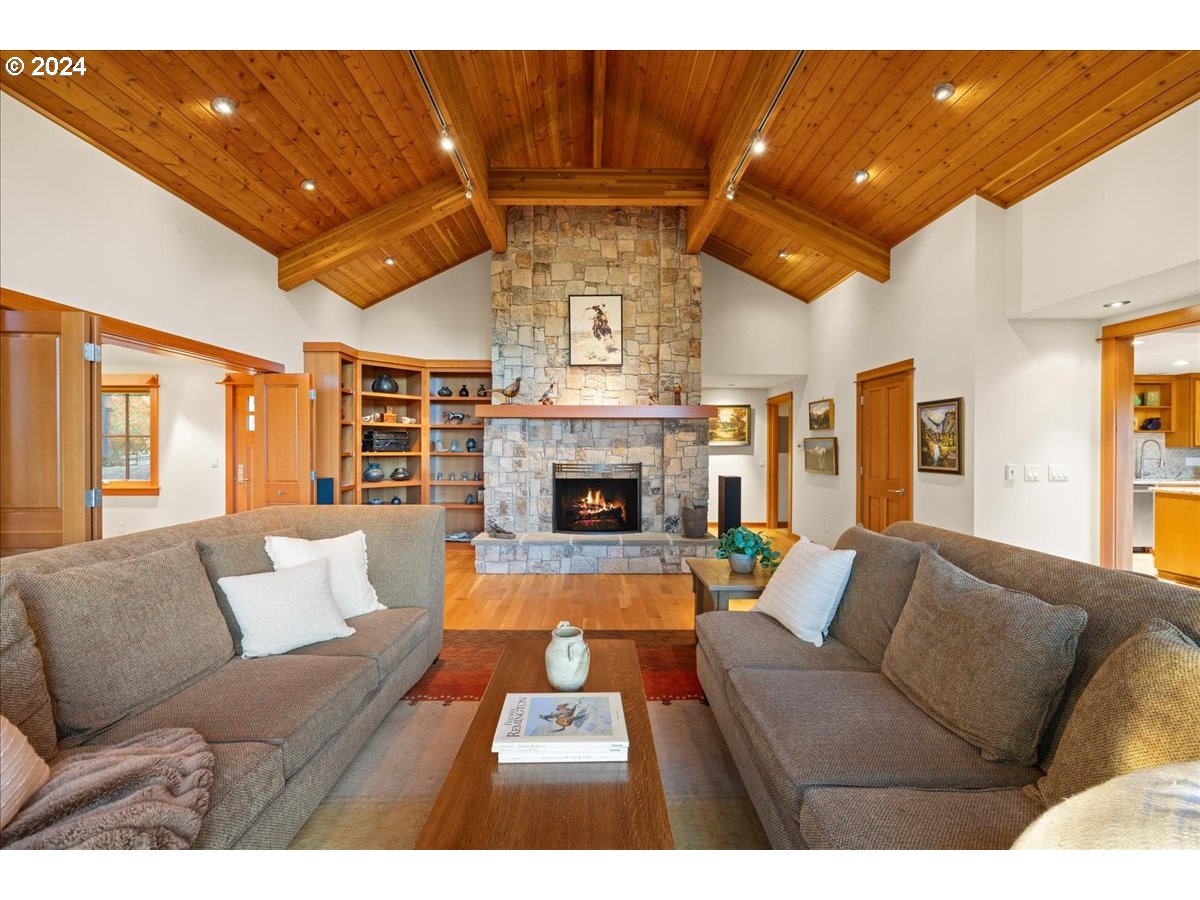 18650 South Lyons Road Oregon City, OR 97045 - Photo 13 of 47 a living room with furniture a large window and a fireplace