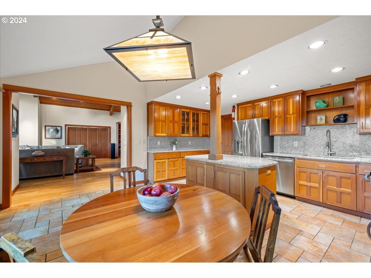 18650 South Lyons Road Oregon City, OR 97045 - Photo 16 of 47 a living room with stainless steel appliances furniture a chandelier and a kitchen view