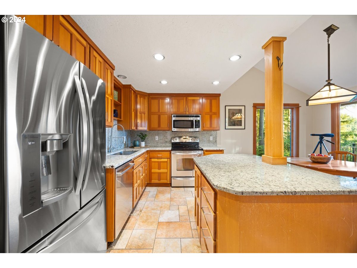 18650 South Lyons Road Oregon City, OR 97045 - Photo 18 of 47 a kitchen with stainless steel appliances granite countertop a sink a stove and a refrigerator
