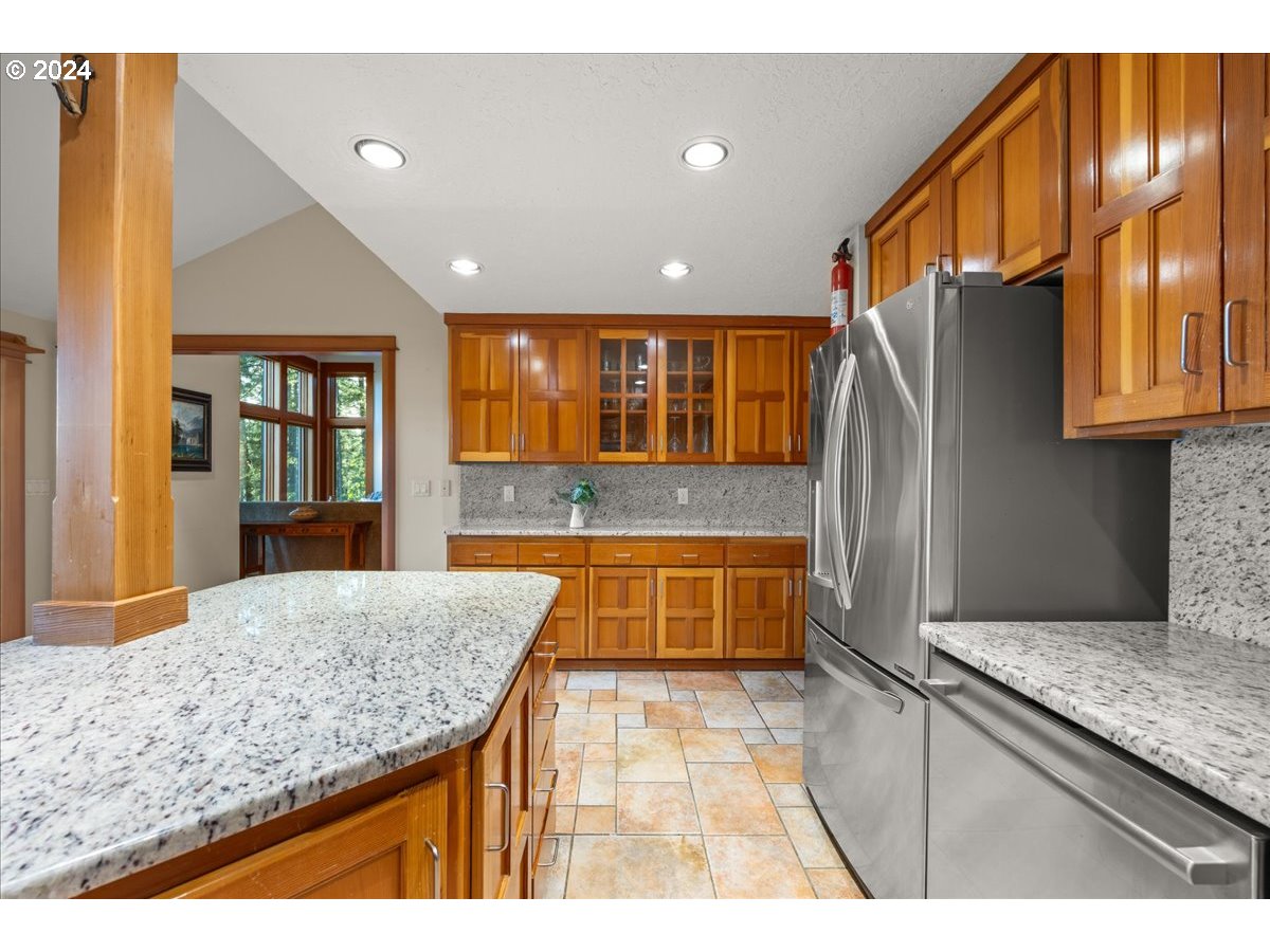 18650 South Lyons Road Oregon City, OR 97045 - Photo 20 of 47 a kitchen with stainless steel appliances granite countertop a sink and a refrigerator
