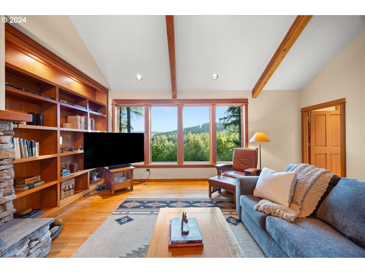 18650 South Lyons Road Oregon City, OR 97045 - Photo 26 of 47 a living room with furniture a flat screen tv and a large window