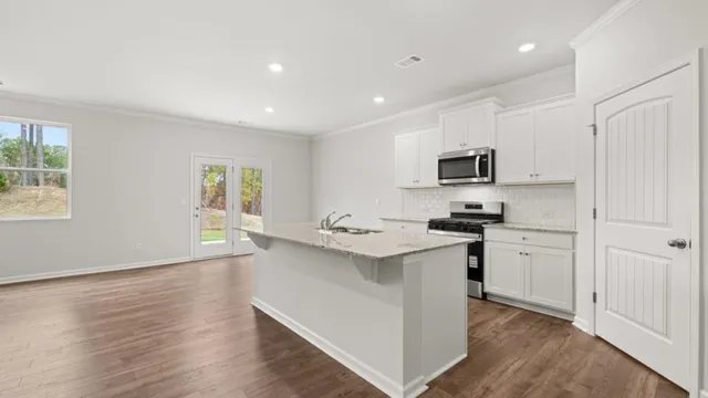 a kitchen with appliances cabinets and a sink