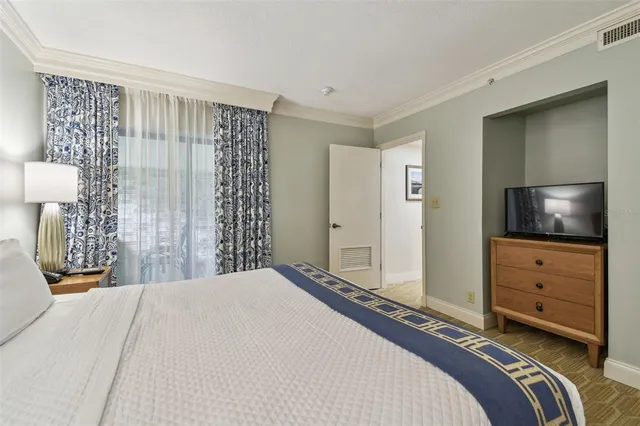 a bedroom with a bed and a view of bathroom