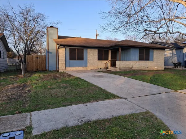 a front view of a house with a yard and a garage