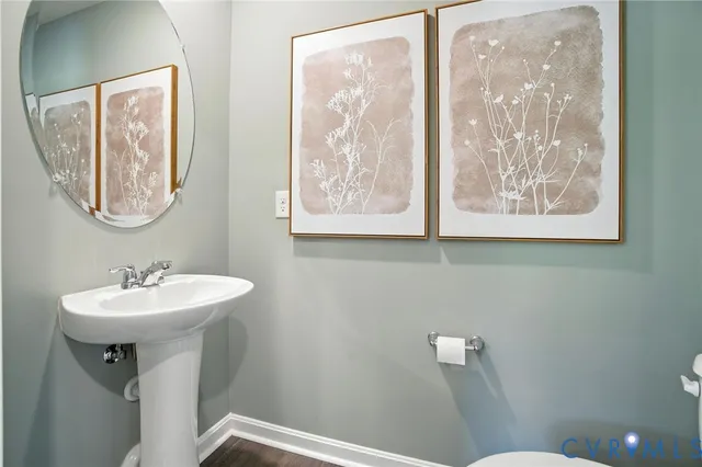 a bathroom with a sink mirror and toilet