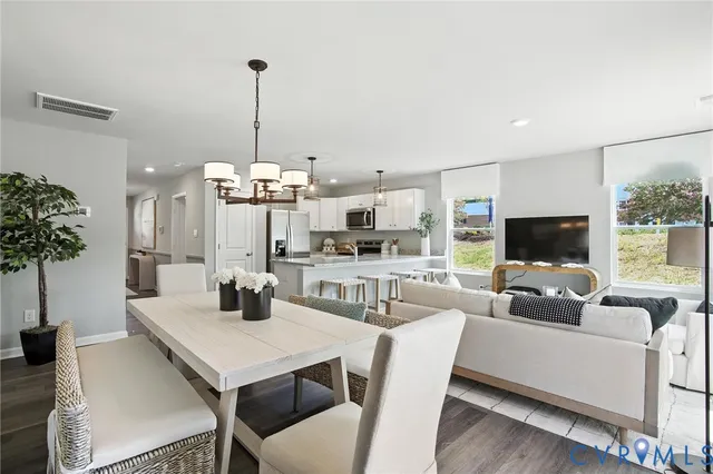 a view of a dining room with furniture and a chandelier