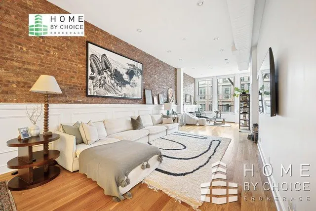 a living room with furniture and a painting on the wall