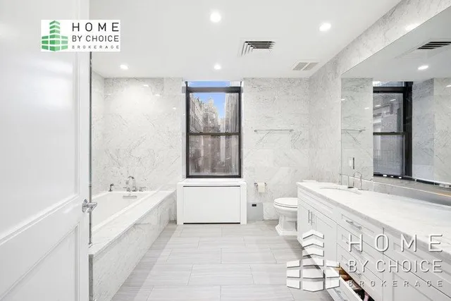 a bathroom with a bathtub shower sink and a toilet