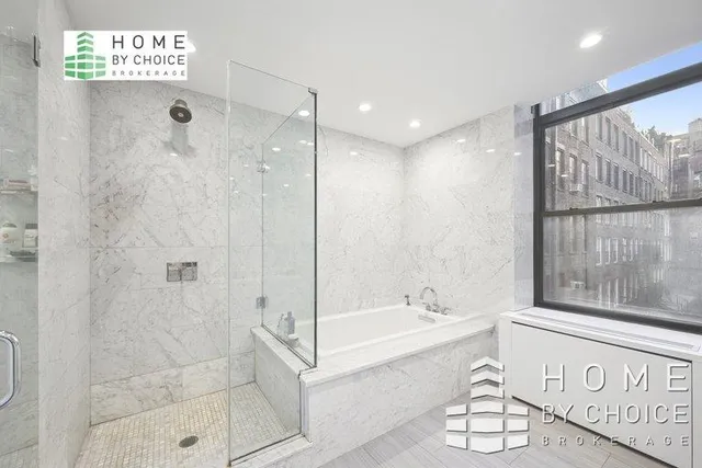 a bathroom with a bathtub and a shower