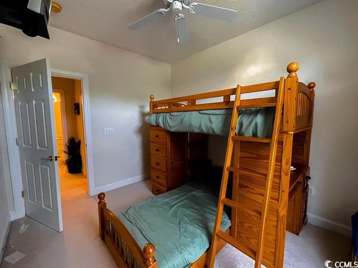 1101 Peace Pipe Place, Unit 104 Myrtle Beach, SC 29579 - Photo 10 of 22 Carpeted bedroom featuring baseboards and ceiling fan
