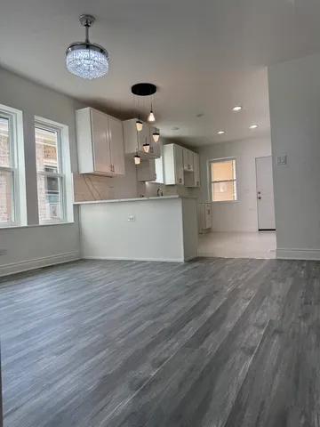 a kitchen with kitchen island a stove a refrigerator and a sink