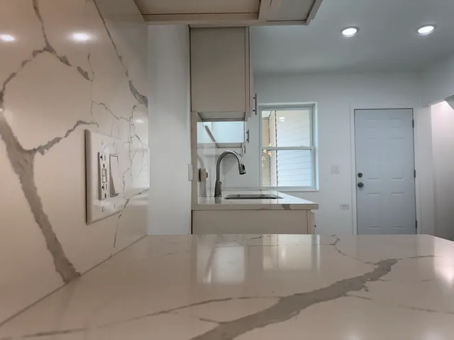 a kitchen with a sink and chandelier