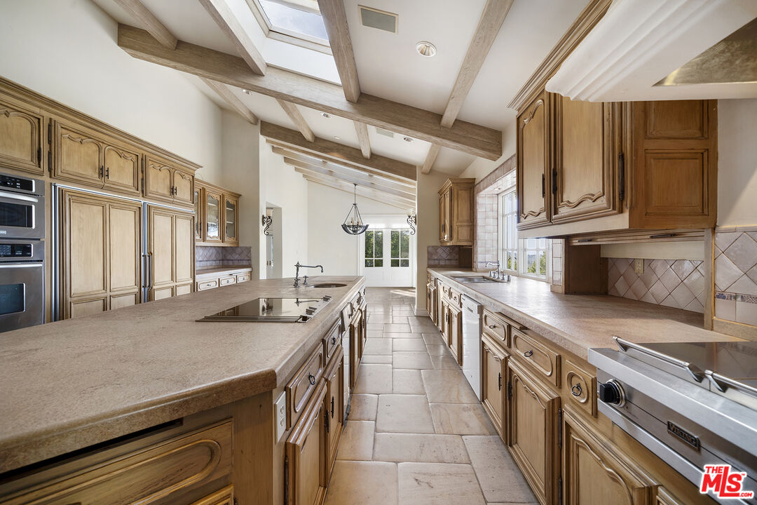 74 Saddleback Road Rolling Hills, CA 90274 - Photo 12 of 65 a kitchen with stainless steel appliances stove microwave and cabinets