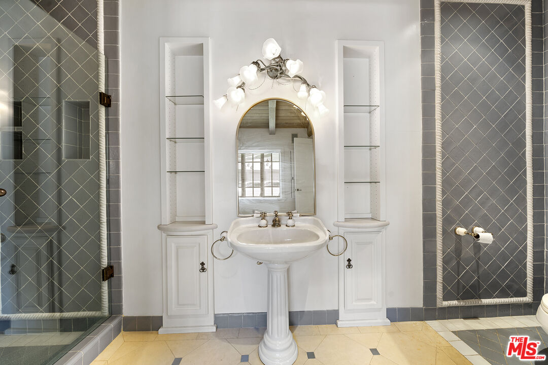 74 Saddleback Road Rolling Hills, CA 90274 - Photo 25 of 65 a bathroom with a sink a mirror and a shower