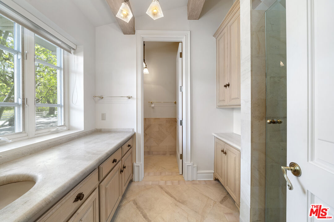 74 Saddleback Road Rolling Hills, CA 90274 - Photo 38 of 65 a bathroom with a granite countertop sink and a mirror